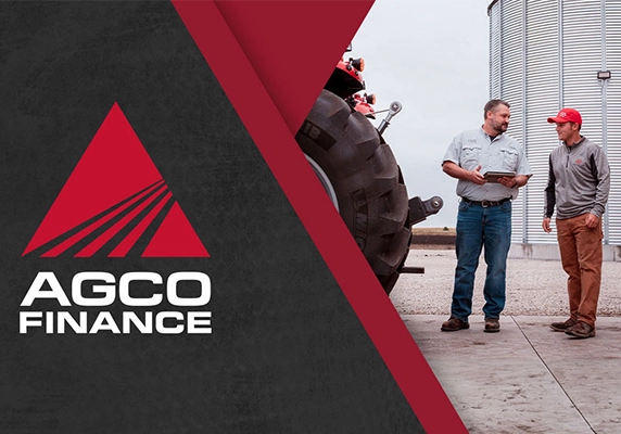 Two men standing beside a tractor and grain bin discussing financing options, alongside AGCO Finance logo on a red and black background.