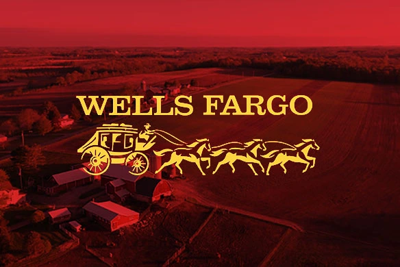 Wells Fargo logo over a red-tinted aerial view of farmland and barns, symbolizing agricultural financing solutions.
